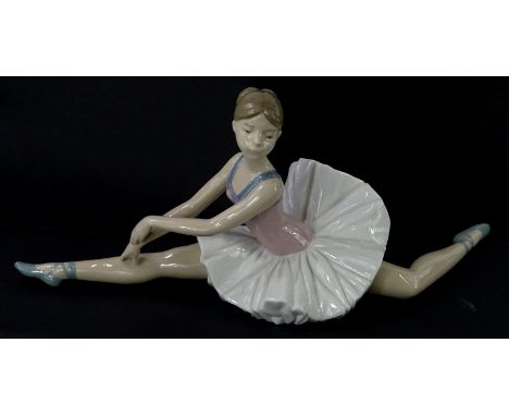 A Nao porcelain model of a seated ballet dancer, 38cm wide.