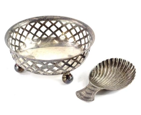 A 19thC silver shell shaped caddy spoon, with engraved handle and a pierced silver bon bon dish on bun feet, 1½oz.