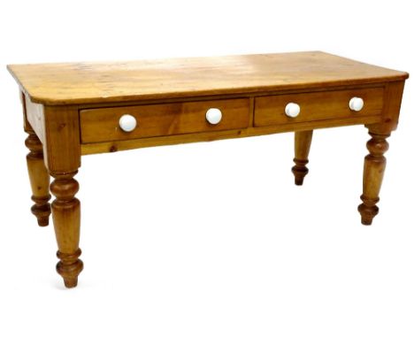 A Victorian pine diary type table, with a planked top, with canted corners, with two frieze drawers, each with ceramic handle