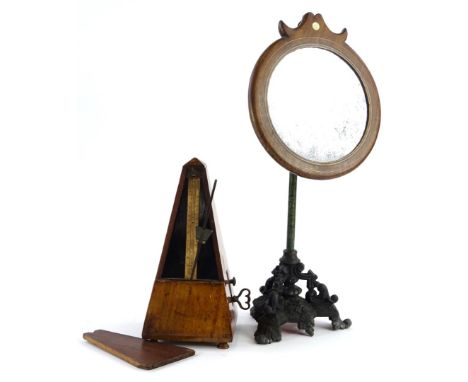 A late Victorian ebonised spelter and brass shaving stand, with circular inlaid wooden mirror, etched column and rococo scrol