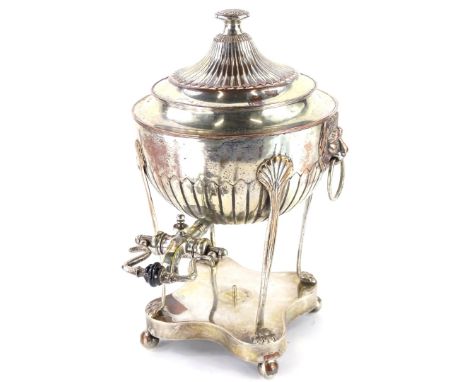 A 19thC silver plated tea urn, with lion mask side handles and a shaped spout with ceramic insulator on bun feet, 32cm high.