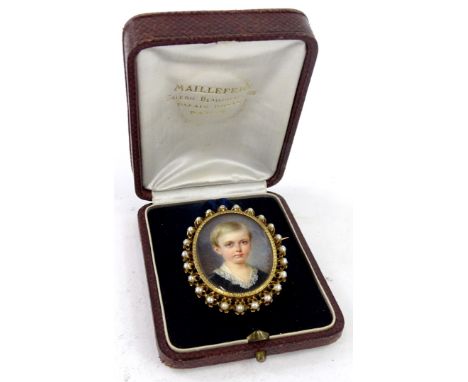 19thC School.  Miniature portrait of a young boy wearing a black garment with lace collar, within gilt metal frame backed wit