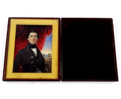 19thC School.  Portrait miniature of a gentleman wearing a black jacket, with tree lined landscape to the rear, in rectangula