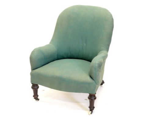 A Victorian mahogany armchair, upholstered in green fabric on turned tapering legs, with ceramic castors.  Provenance: The Es