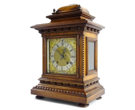 A late 19th/early 20thC German walnut mantel clock, the case decorated with beading reel, applied with turned brass finials, 