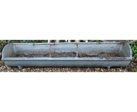 A cast iron agricultural feeding trough, of bowed shape, 152cm wide.