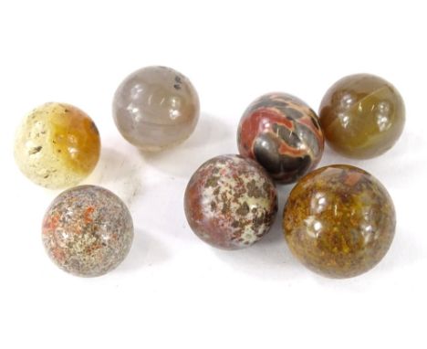 Seven 19thC ceramic and semi precious stone marbles. Provenance: The Estate of Miss Rachel Monson.