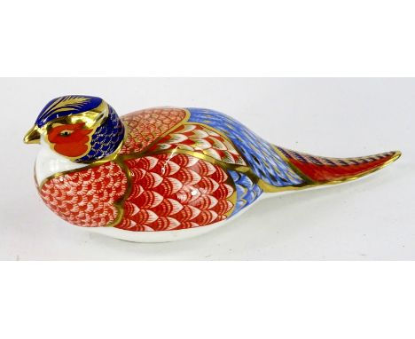 A Royal Crown Derby porcelain pheasant paperweight, silver button to underside.