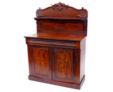 A Victorian mahogany chiffonier, the raised back decorated with shells, leaves, etc., with a single shaped shelf, the base wi