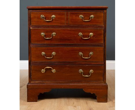 A Georgian style mahogany chest of four long drawers with brass swan neck handles and brass carrying handles, all raised on b