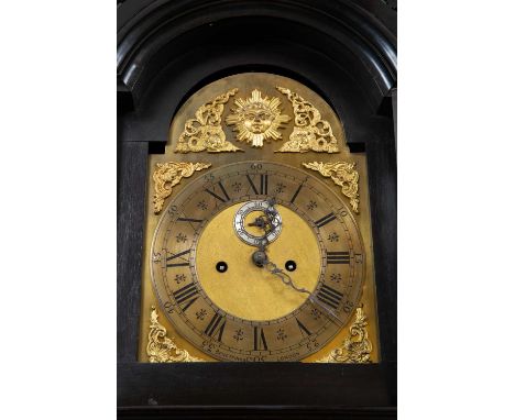 A Victorian ebonised longcase clock with fret carved breakarch pediment and brass dial with arabic and roman numerals, signed