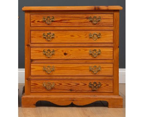 A pair of pine bedside tables of four drawers on bracket feet, 59cm wide x 40cm deep x 60cm high (2) Condition report: At pre