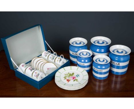Four Cornish kitchenware blue and white pottery storage jars marked 'Sugar', 'Flour', 'Sultanas' and 'Sago' and a larger Gree