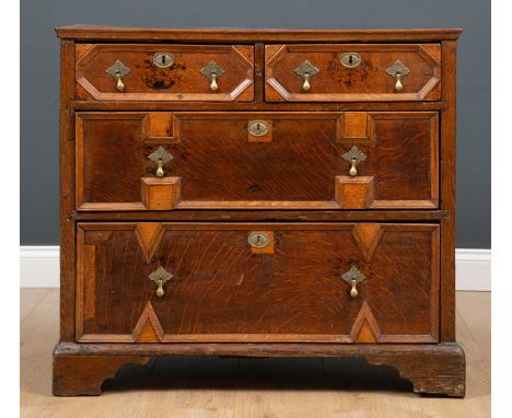 A 17th century oak chest of two short and two long drawers with brass teardrop handles and bracket feet, 86cm wide x 52cm dee