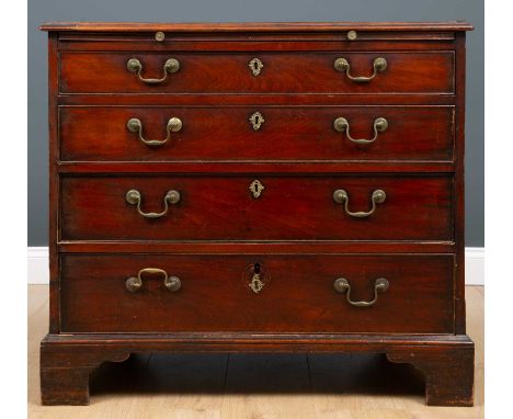 A George III mahogany chest of four long drawers having a slide and brass swan neck handles, raised on bracket feet, 91cm wid