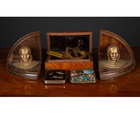 A pair of bookends with native American head brass mounts, 14cm wide x 13cm deep x 13cm high together with a pair of cigarett