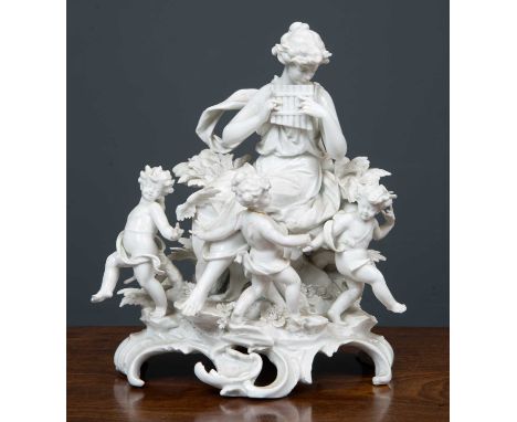 A late 19th century continental white porcelain group, of a female panpipe player surrounded by cherubs on a rococo base, 22c