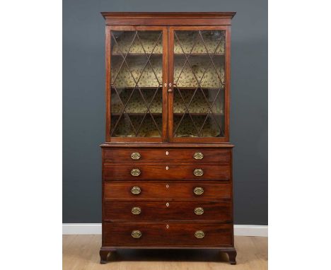 A George III mahogany secretaire bookcase with twin astragal glazed doors above secretaire drawer and three long drawers, all