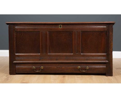 An oak mule chest with single long drawer and three panelled front on bracket feet, with iron carrying handles, 127cm wide x 