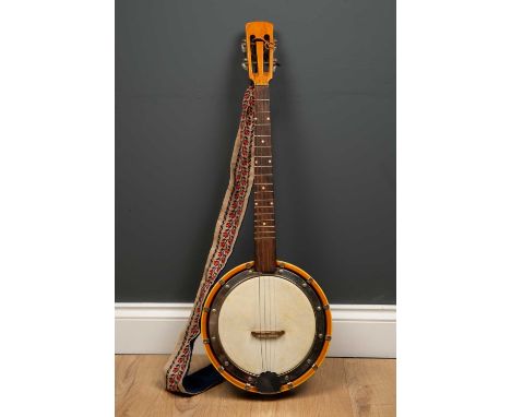 A four string banjo, with tapestry decorated strap in a black bound and green fabric lined case, 77cm longCondition report: W