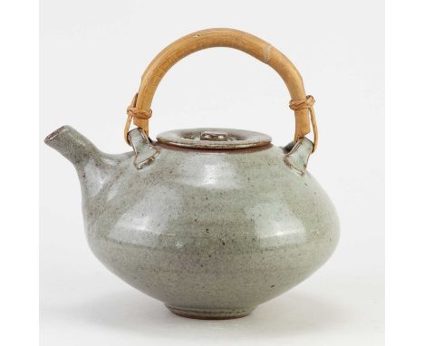 JOHN REEVE (1929-2012) for Leach Pottery; a stoneware teapot with cane handle covered in speckled grey glaze, impressed marks