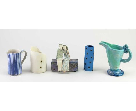 A group of studio ceramics comprising a sculpture of a couple on a bench by Helen Martino, a tea light holder by Brittany Del