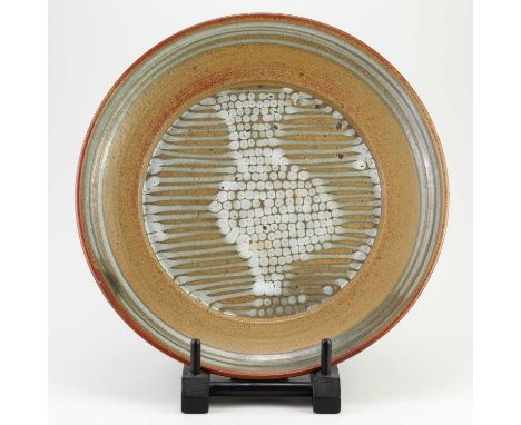 † DAVID LLOYD JONES (1928-1994); a stoneware charger covered in iron rich and oatmeal glaze with a band of green glaze below 