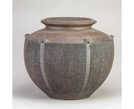 † JENIFER JONES (born 1940); a large stoneware lugged planter with red rust surface and a broad band of incised vertical deco