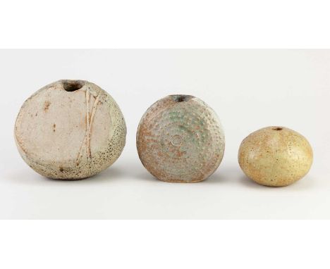 † ALAN WALLWORK (1931-2019); a stoneware pebble, incised W mark, height 11.5cm, and a small fossil form and sea urchin (3).Co