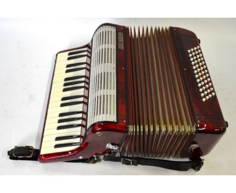 A red-marbled cased Egisto Bontempi piano accordion with 34 keys and 48 buttons, in simulated crocodile-skin case