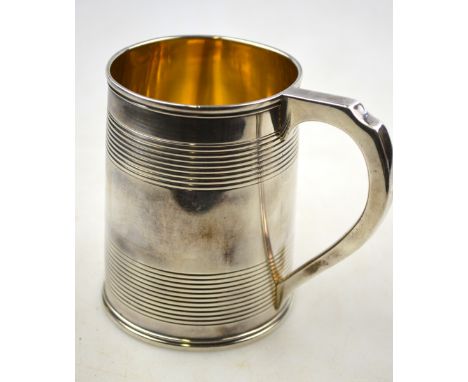 A George III silver mug of tapering cylindrical form with banded decoration, maker (probably) William Bennett, London 1817, 6