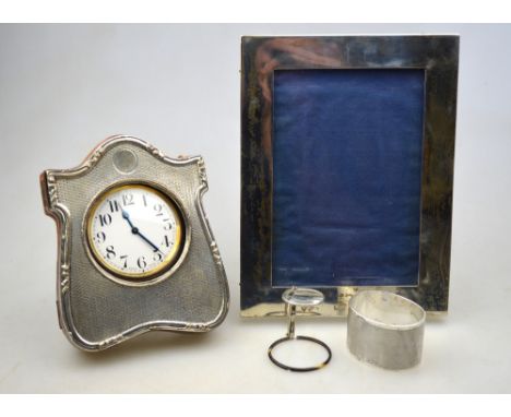 An Edwardian silver-faced travelling watch case with engine-turned decoration and crocodile-hide back, containing an electrop