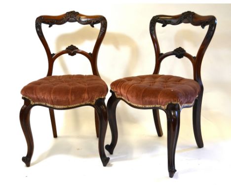 Set of six Victorian carved rosewood side chairs with button upholstery overstuffed serpentine form seats, on club front legs