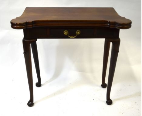 An antique mahogany card table, the shaped fold over baize lined top over a frieze drawer, raised on club gatelegs to pad fee