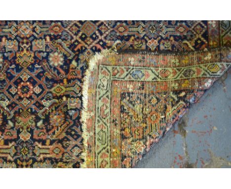 An antique Persian Hamadan rug, 1st quarter 20th century, the repeating linked geometric design on blue ground, 1.85 x 1.30 m
