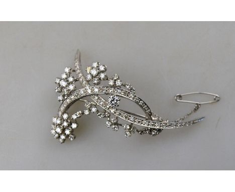 A 1950s style diamond-set double crescent and spray brooch set overall with mostly eight-cut diamonds in white metal millgrai