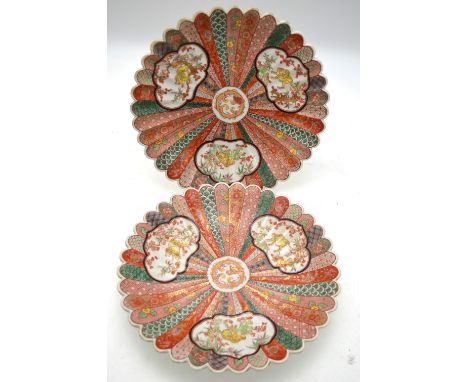A pair of Japanese polychrome dishes, each one decorated with panels depicting tigers, the bases with underglaze blue six cha