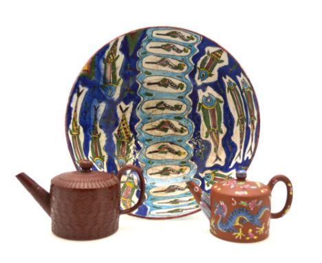 An Iznik bowl, the interior decorated with fish in the traditional style, 32 cm diam, to/w a Yixing teapot with famille rose 