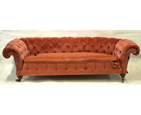 A Victorian button backed Chesterfield sofa by Howard & Sons, London, the back castors stamped, the back leg stamped '12451/8