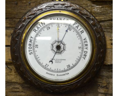 Broom, Reid & Harris, 2 Queen Street, Exeter, a late 19th century oak cased circular aneroid barometer having a white ceramic