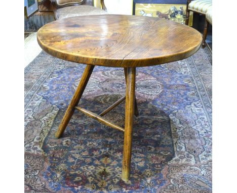 An elm cricket table, the circular top raised on tripod legs united by a 'T' stretcher, 85.5 cm diam x 70 cm high Condition R