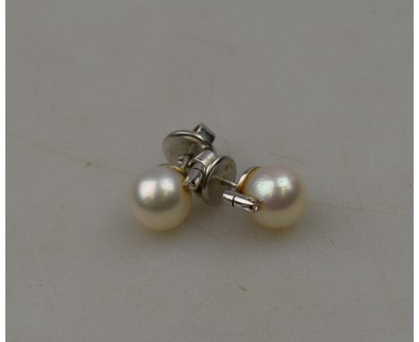 A pair of cultured pearl and eight cut diamond stud earrings, white metal set stamped 14k