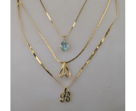 An oval aquamarine and diamond pendant on yellow metal chain stamped 14k to/w a yellow metal scroll style pendant set with tw