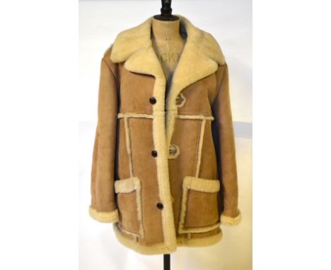 A gentleman's vintage pale tan sheepskin coat retailed by Tabcare Ltd., with three leather button fastenings, 60 cm across ch