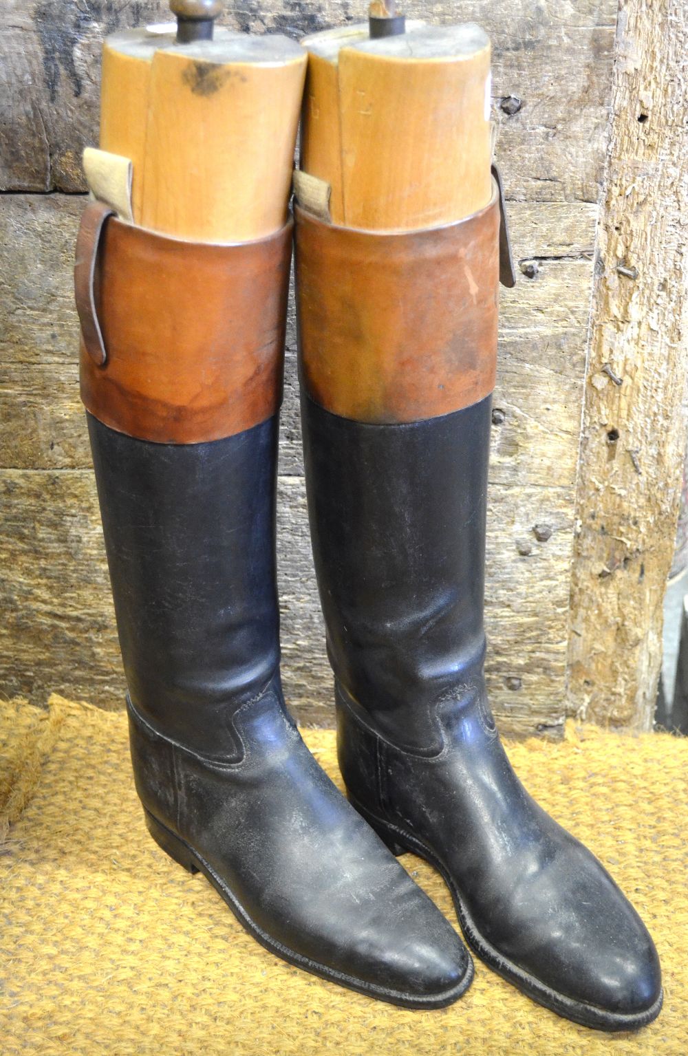 Two pairs of vintage leather hunting boots with tan leather cuffs, c/w