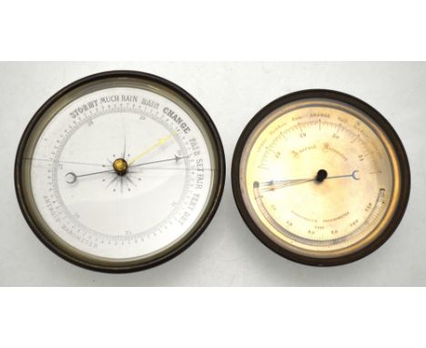 A 19th century aneroid barometer, the silvered dial with carved mercury thermometer, in brass drum case, 12 cm diameter, to/w