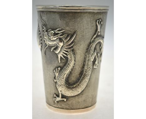 A Chinese silver beaker of tapering form embossed and chased with dragons guarding a flaming peach, stamped for Luen-Wo, Shan