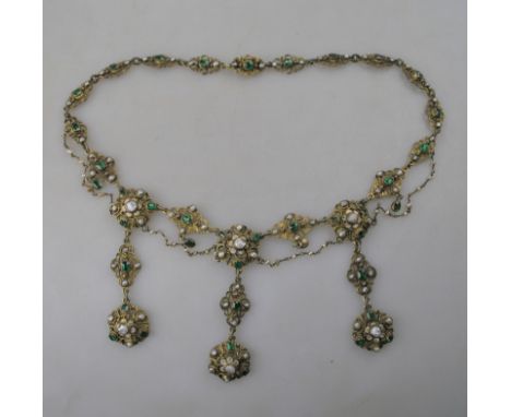 An Austro-Hungarian gilt metal necklace in fringe renaissance style set with green stones, blister and river pearls with whit