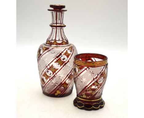 A Bohemian ruby flash glass night time water decanter and stopper with matching tumbler having etched writhen star cut bands,