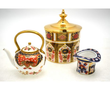 A Royal Crown Derby 'Old Imari' jam pot c/w brass cover to/w a Royal Crown Derby miniature teapot and an Imari decorated matc